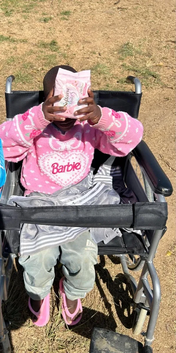 A dignity kit being shared with a girl in a wheelchair